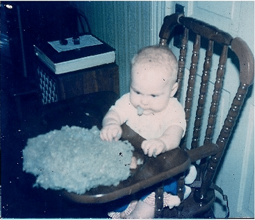 Baby picture of Hap's daughter playing with cellulose insulation